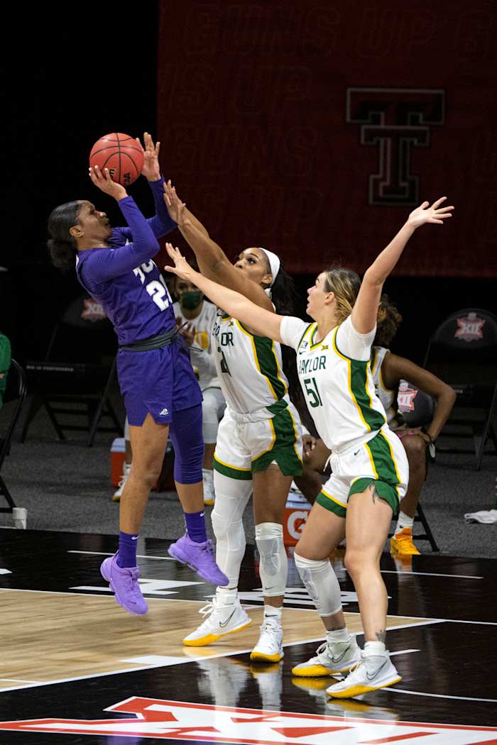 Mar 12, 2021; Kansas City, Missouri, USA; Baylor Lady Bears guard DiJonai Carrington (21) and Baylor Lady Bears forward Caitlin Bickle (51) defend a shot by TCU Horned Frogs guard Lauren Heard (20) in the first half at Municipal Auditorium.